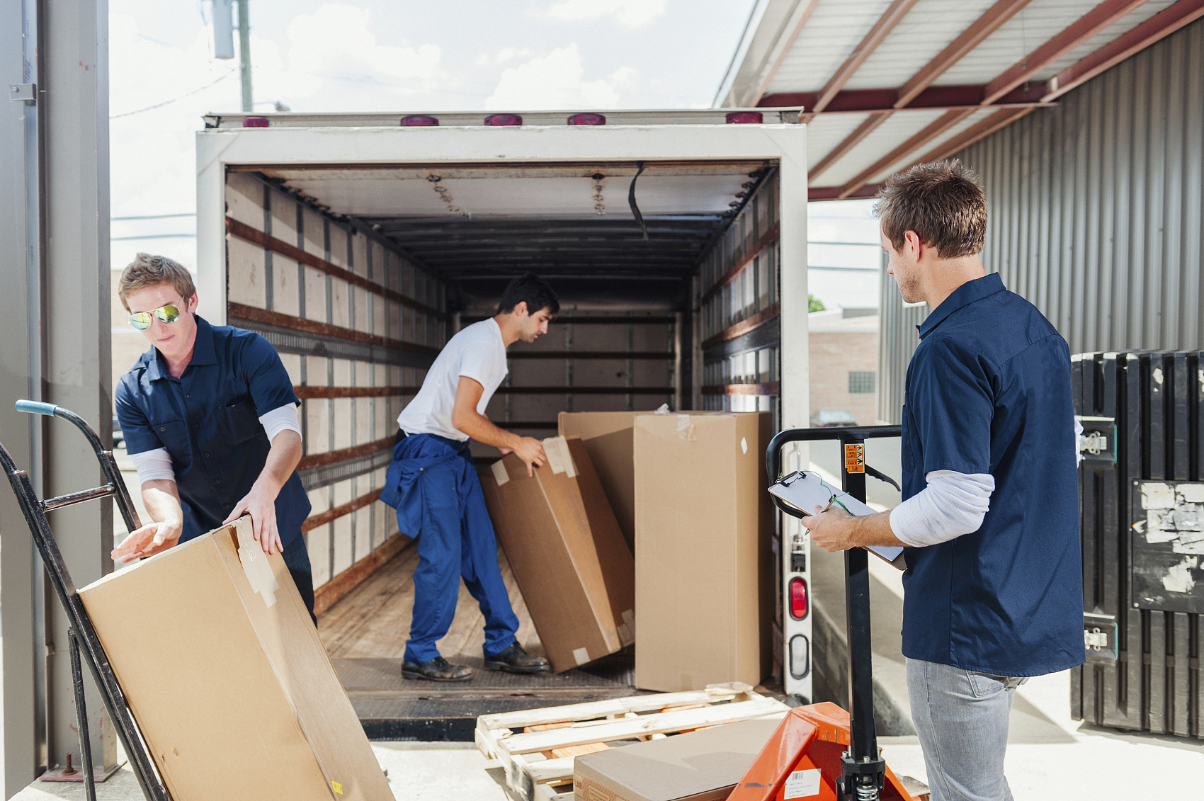 Heavy machinery being loaded into a 40HQ container