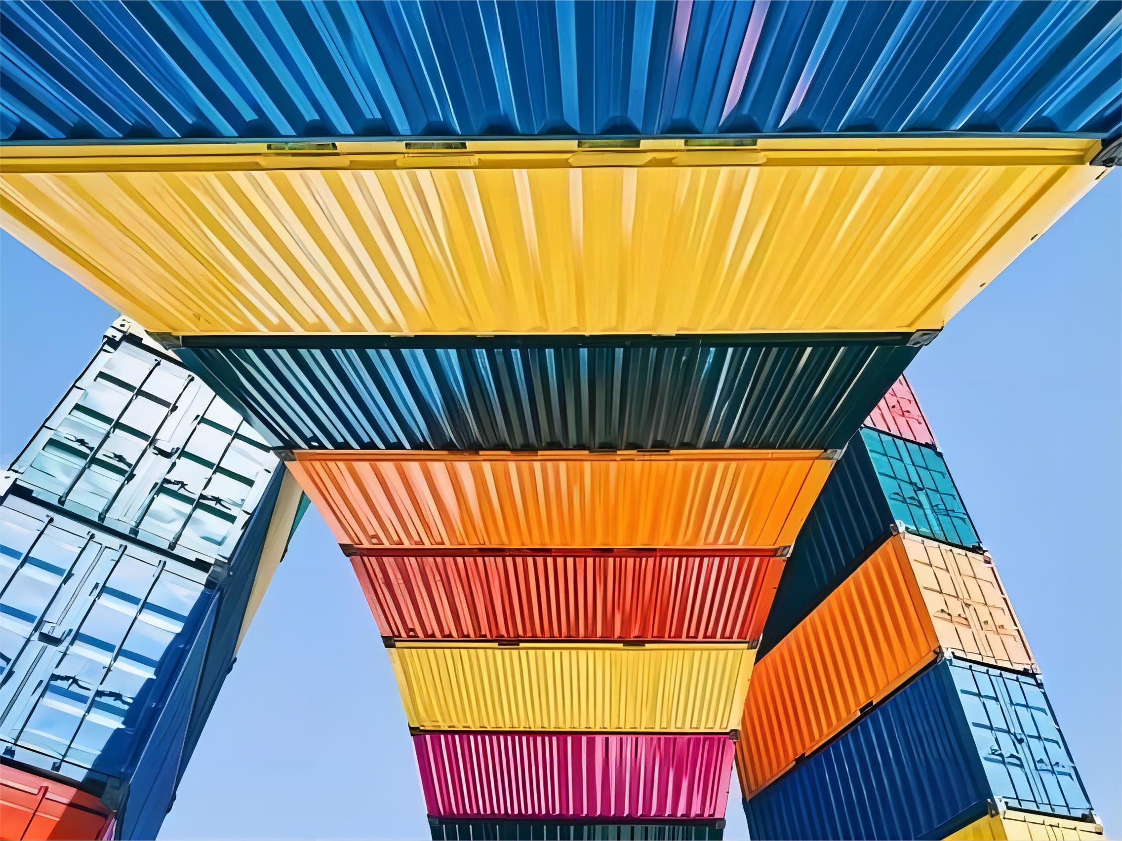 Large machinery being loaded into a 40GP container at a port